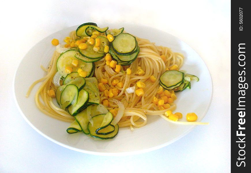 Photo of pasta with zucchini and corn.