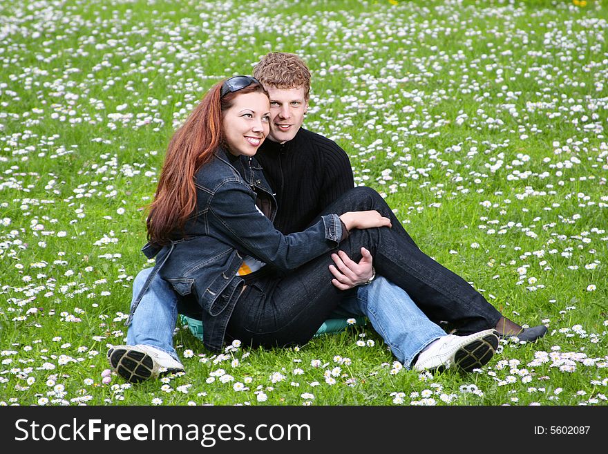 Happy young couple relaxing outdoors. Happy young couple relaxing outdoors
