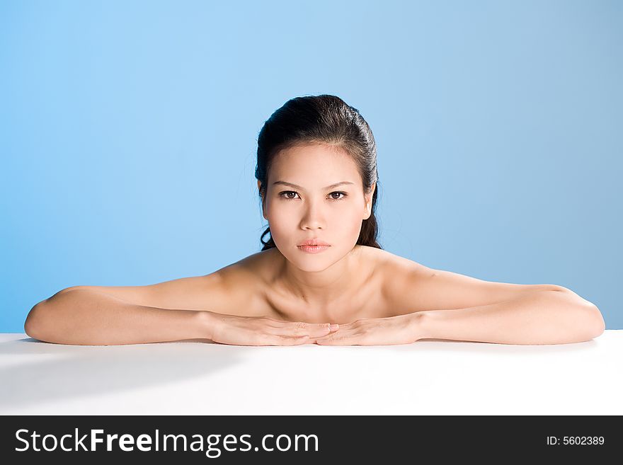 Refreshing and clean face of young woman with her hand lean on white surface. Refreshing and clean face of young woman with her hand lean on white surface