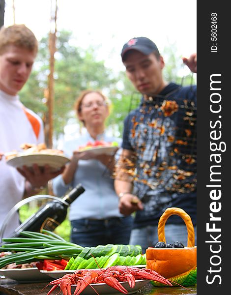 Friends having a picnic outdoors. Friends having a picnic outdoors