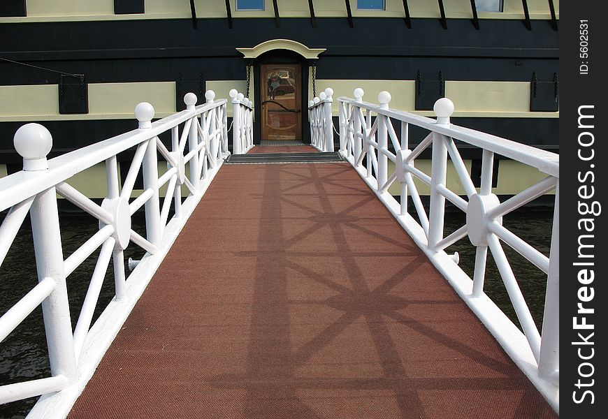 The front ship's ladder with white banisters and brown carpet strip