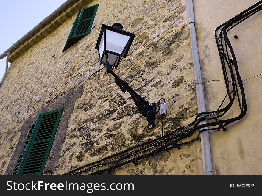 Stony wall in a village with very old fashion electric system. Stony wall in a village with very old fashion electric system