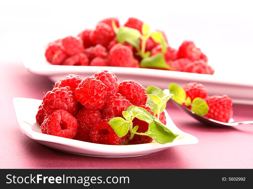 Very fresh raspberries on white plate