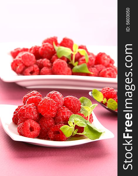 Very fresh raspberries on white plate