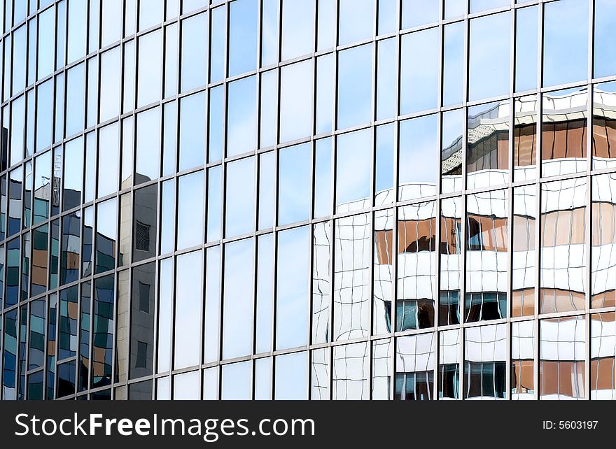 Modern corporate buildings reflected in office glass. Modern corporate buildings reflected in office glass.