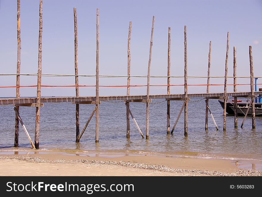 The wooden pier to the ferry boat from Texel to Vlieland. The wooden pier to the ferry boat from Texel to Vlieland