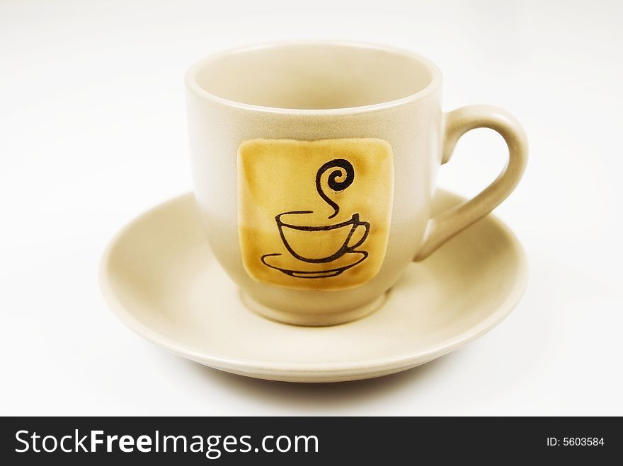 Coffee cup and sauceragainst whote background