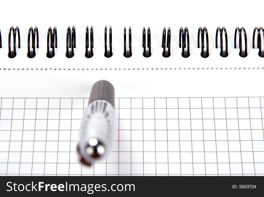 Spiral notepad and pen isolated on white background close-up