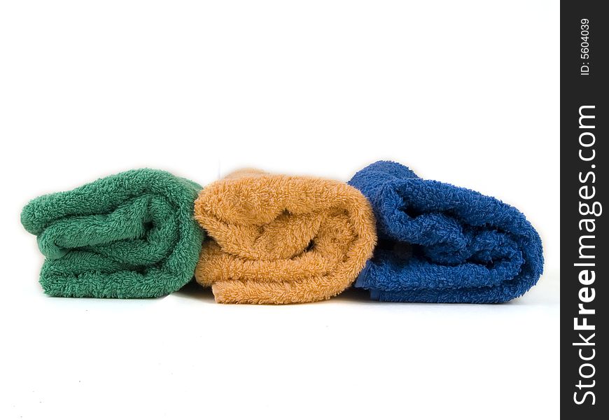 Blue, orange and green towels on white background