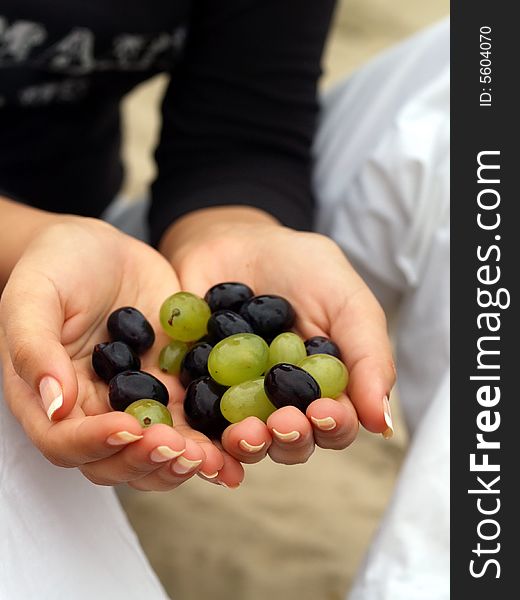 Woman take some grapes in her hands. Woman take some grapes in her hands
