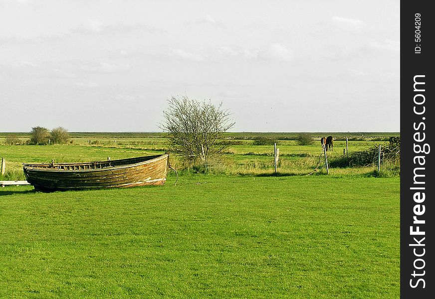 Boat in green landscape of Rømø. Boat in green landscape of Rømø