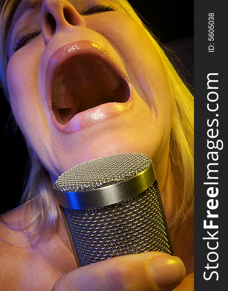 Woman with Microphone Sings with Passion. Woman with Microphone Sings with Passion