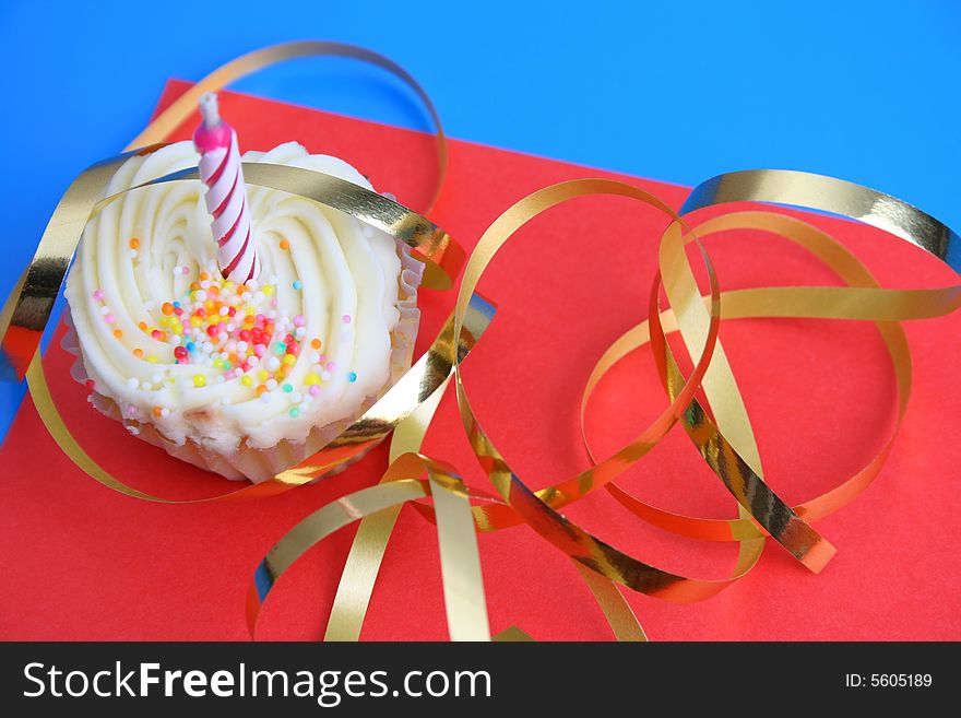 Birthday Cupcake with one candle and gold ribbon