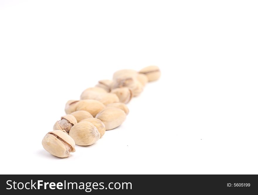 Solted pistachio nut at white isolated background