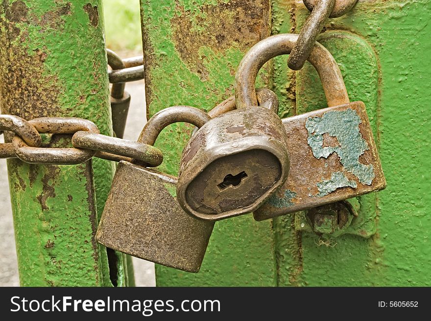 Three rusty padlocks with a chain. Three rusty padlocks with a chain