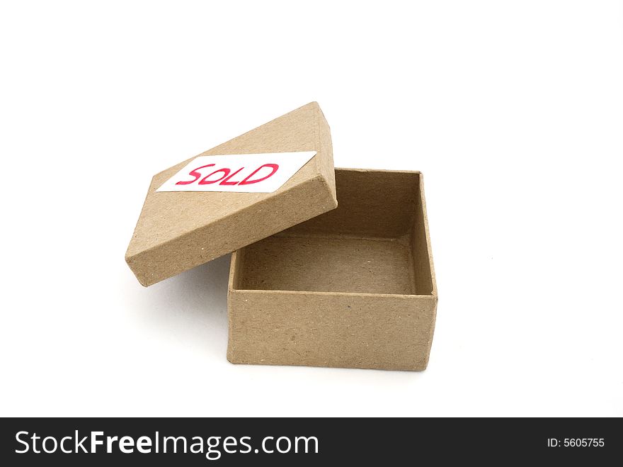 Cardboard box with sold label. Cardboard box with sold label.