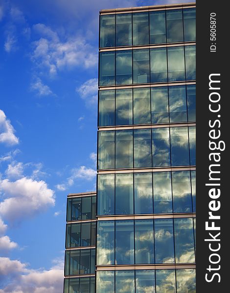 Blue sky reflection on glass modern building