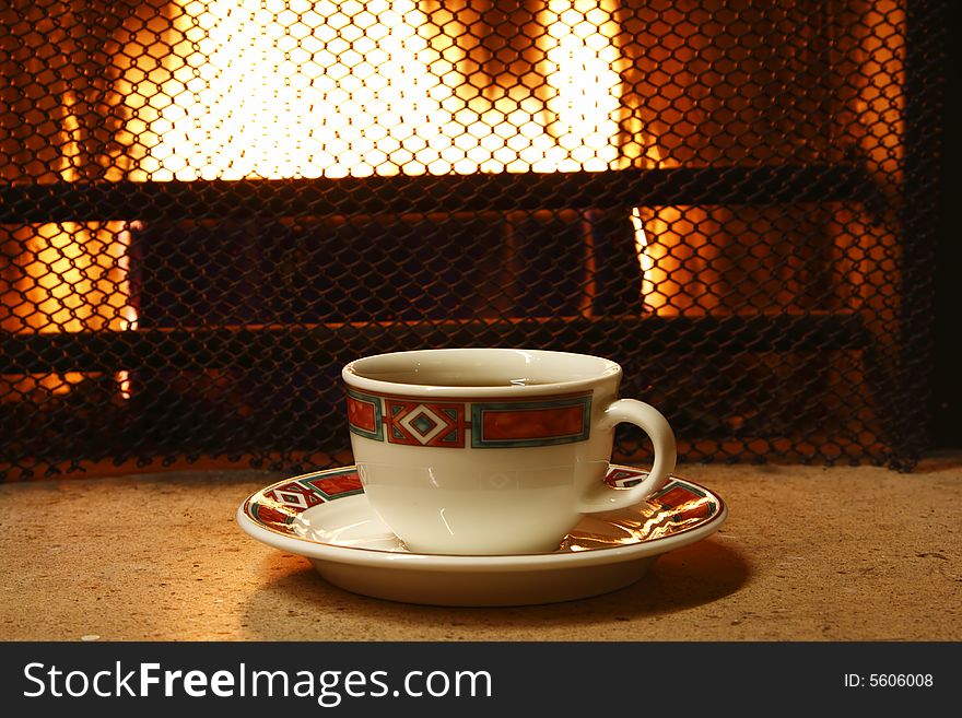 Tea cap on firepalce with fire background. Tea cap on firepalce with fire background