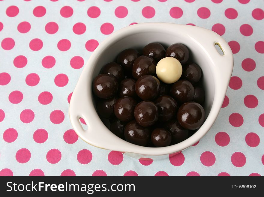 Vanilla and Dark Chocolate balls on a dotty background