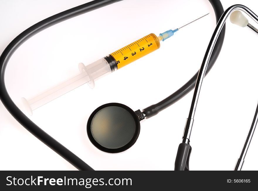 A composition of stethoscope and syringe. A composition of stethoscope and syringe