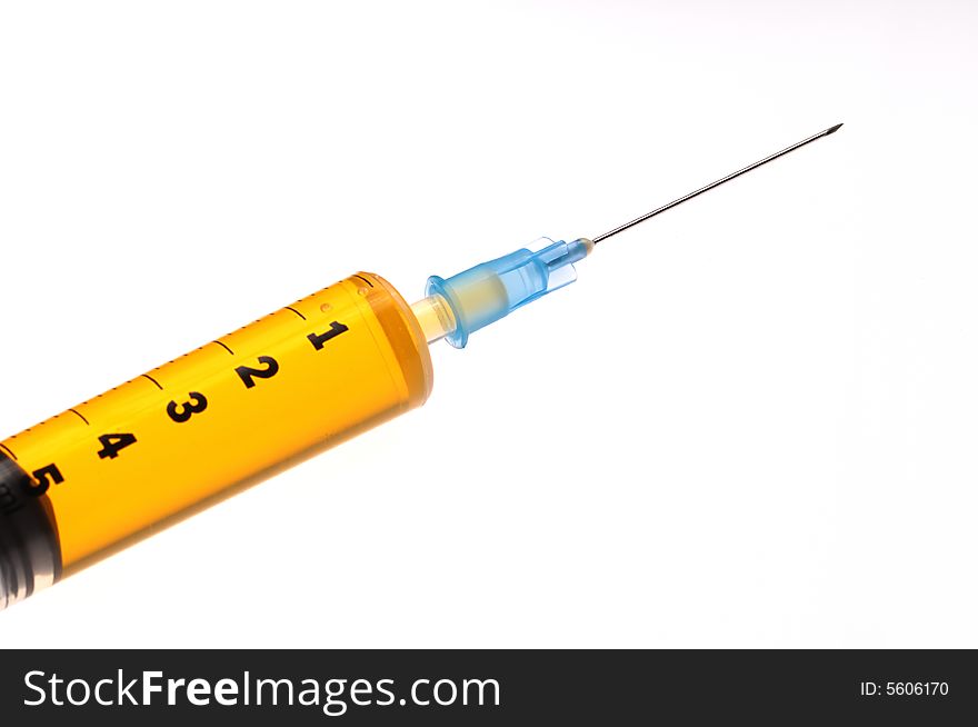 An isolated syringe whit yellow liquid. An isolated syringe whit yellow liquid