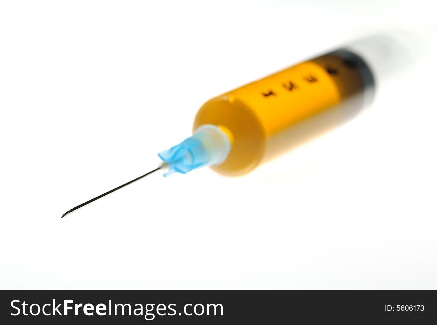 An isolated syringe whit yellow liquid. An isolated syringe whit yellow liquid