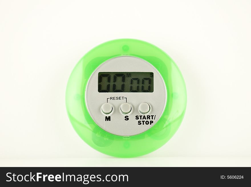 A small green stopwatch set on white. A small green stopwatch set on white.