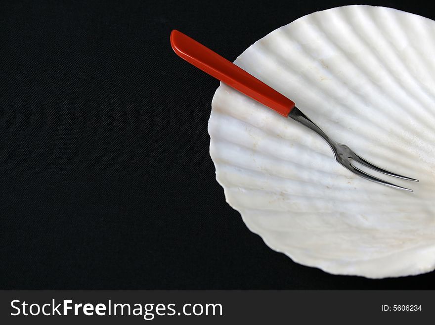 Special small fork and shell plate for seafood starters. Special small fork and shell plate for seafood starters