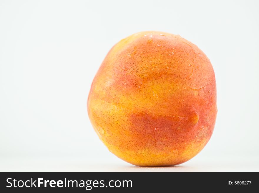 A colourful summer peach isolated on white. A colourful summer peach isolated on white.