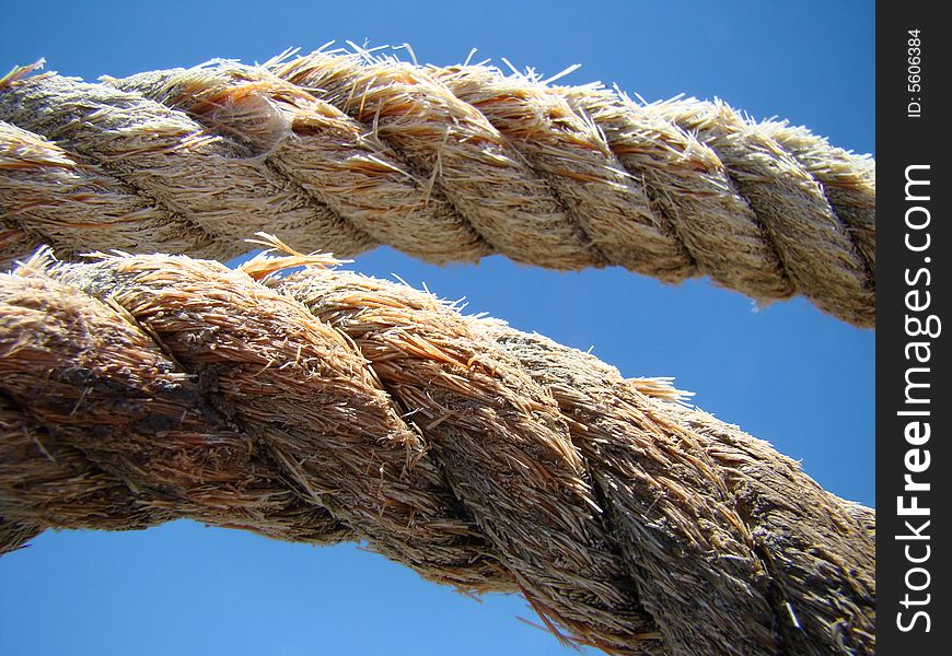 Old fishing boat rope against blue sky