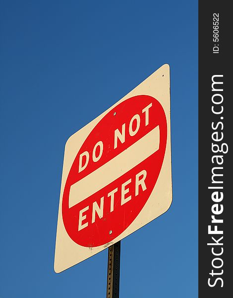 A worms eye view of a street sign in front of a blue sky. A worms eye view of a street sign in front of a blue sky.