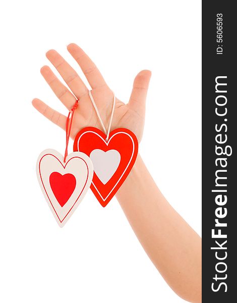 Woman's hand holding two colorful hearts. Woman's hand holding two colorful hearts