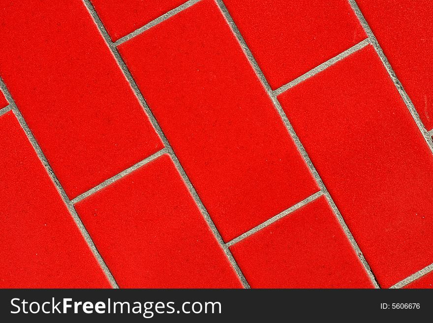 A close up of a red tiled wall.