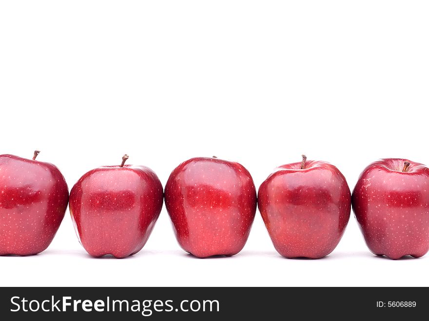 Red apples line up on a white background. Red apples line up on a white background