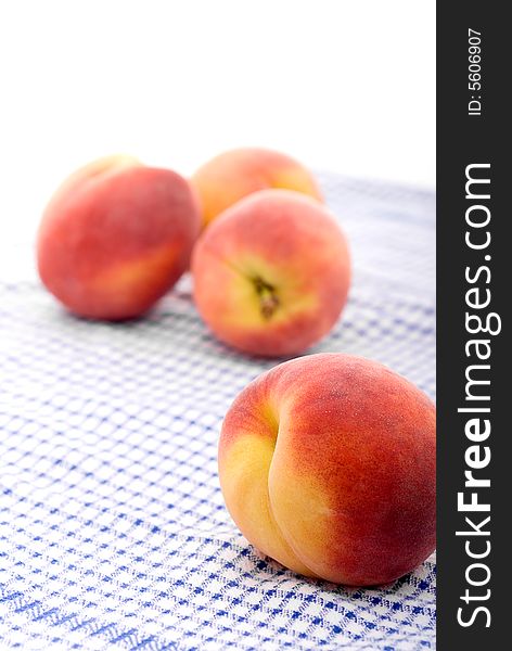 Shallow focus fresh peaches on a kitchen towel