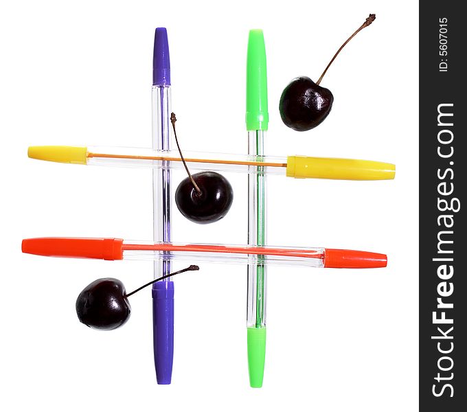 Four colored  ballpoint pens and three cherries on white background. Four colored  ballpoint pens and three cherries on white background