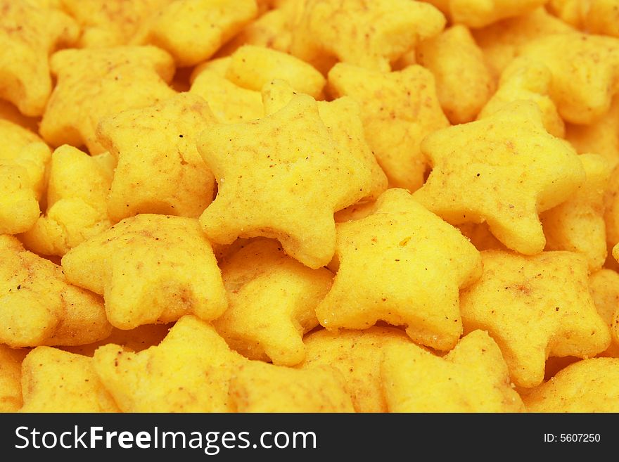 A pile of yellow snacks in star shape. A pile of yellow snacks in star shape.