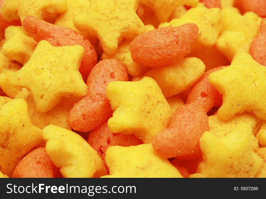 A pile of orange and yellow star snacks.