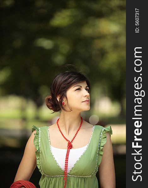 Young lady outdoor looking at the nature around her with a peaceful face. Young lady outdoor looking at the nature around her with a peaceful face