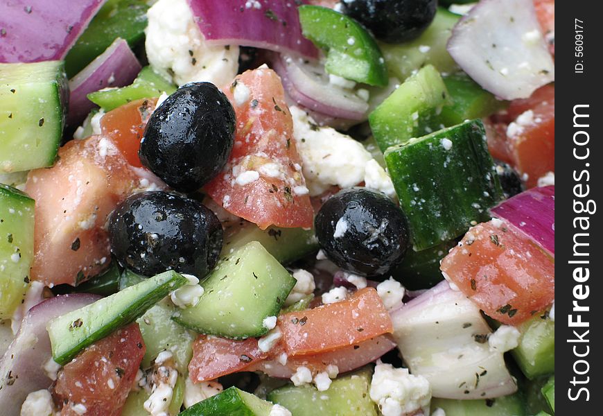 Greek salad with olives, tomatoes, cucumber, onion, feta
