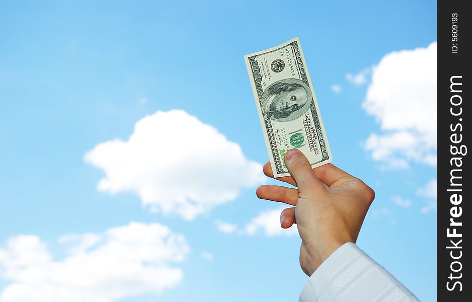Money in hand  isolated on sky background