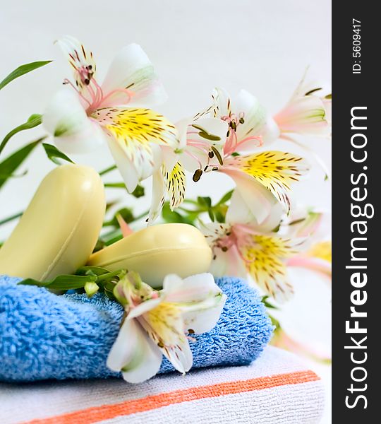 Soap and flower on blue fabric for your design