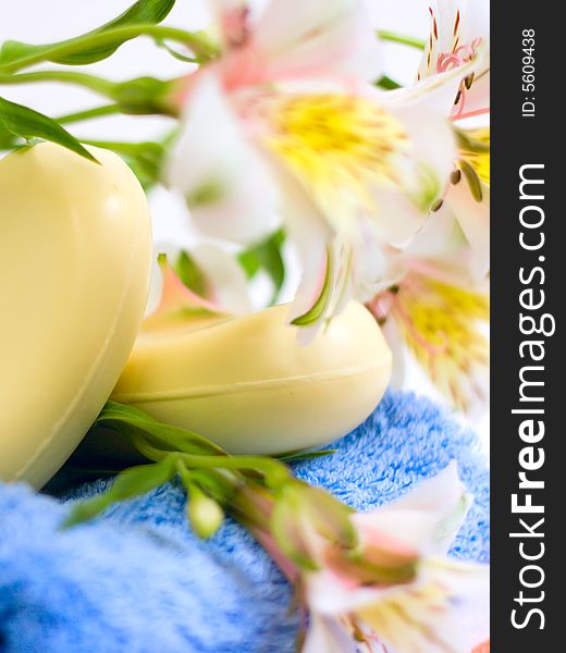 Soap and flower on blue fabric for your design