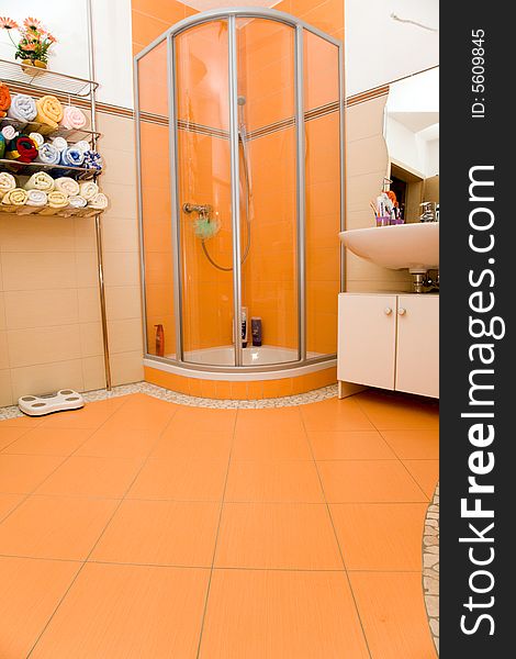 Orange bathroom with a modern shower. Orange bathroom with a modern shower.