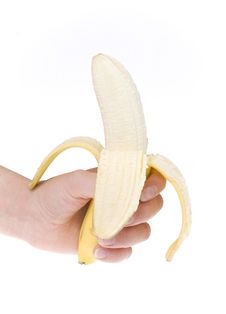 Half Peeled Banana In Hand Royalty Free Stock Photo