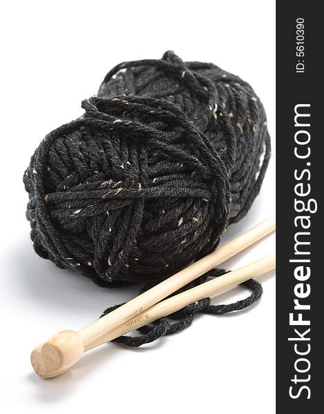 A ball of wool with knitting needles