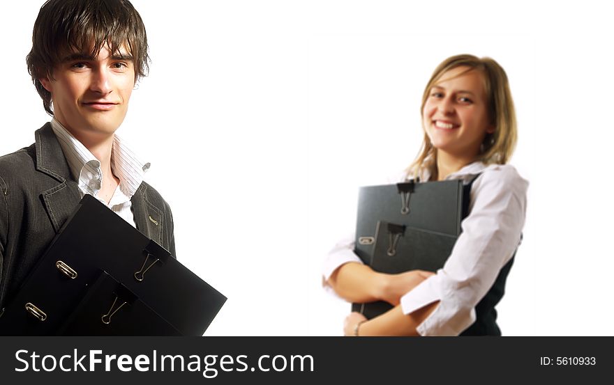 A pretty elegant businesswoman and a young businessman are holding folders. They are wearing elegant white shirts. A pretty elegant businesswoman and a young businessman are holding folders. They are wearing elegant white shirts.