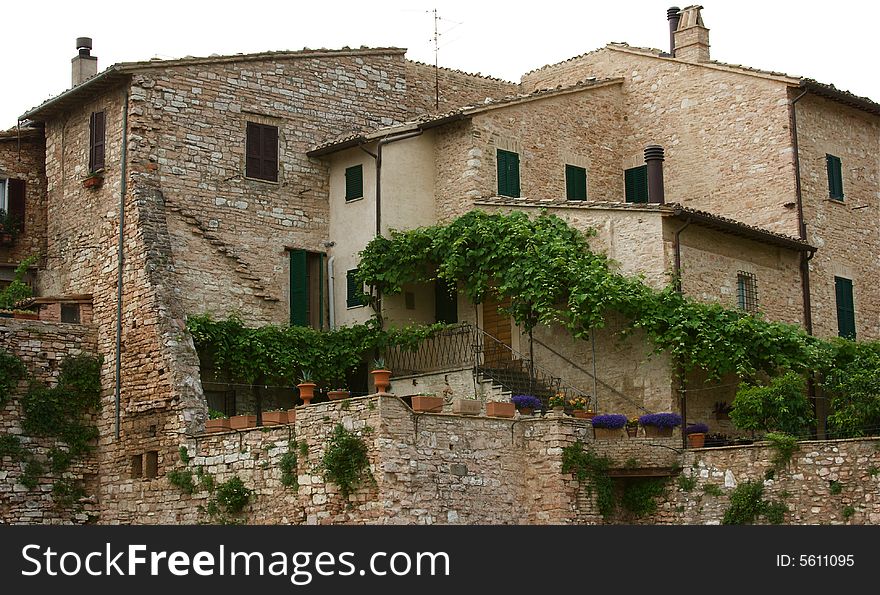 The picturesque historic hill town of Spello in Umbria, Italy. Very old Italian stone houses. The picturesque historic hill town of Spello in Umbria, Italy. Very old Italian stone houses.