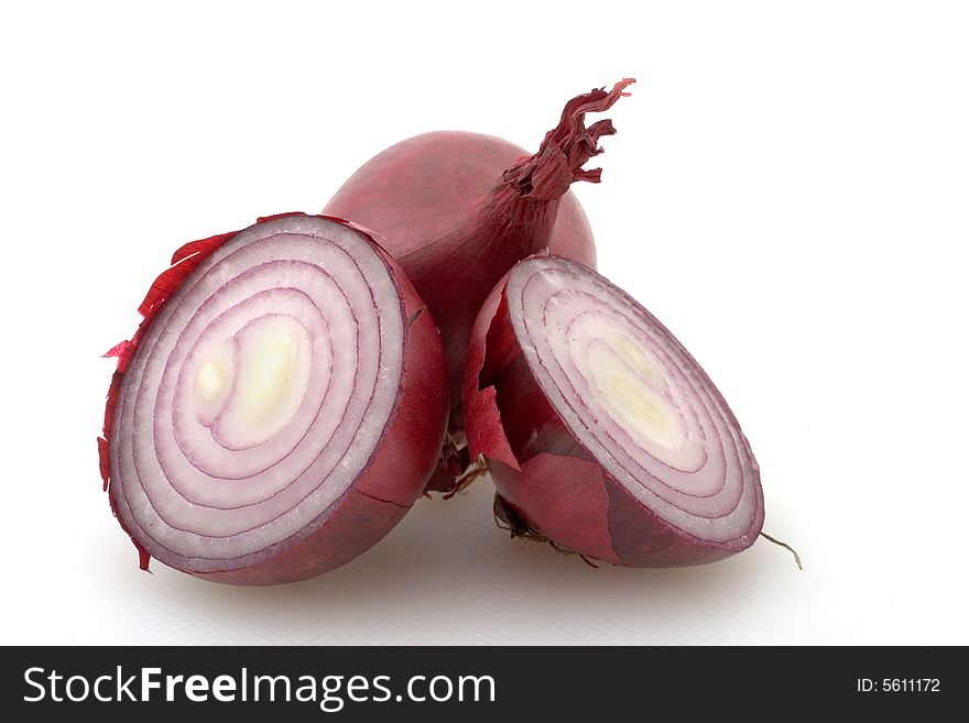 Two red onions on white, one cute in half