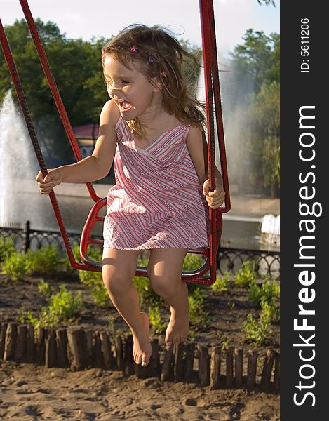 Happy smiling little girl having fun on swing. Happy smiling little girl having fun on swing